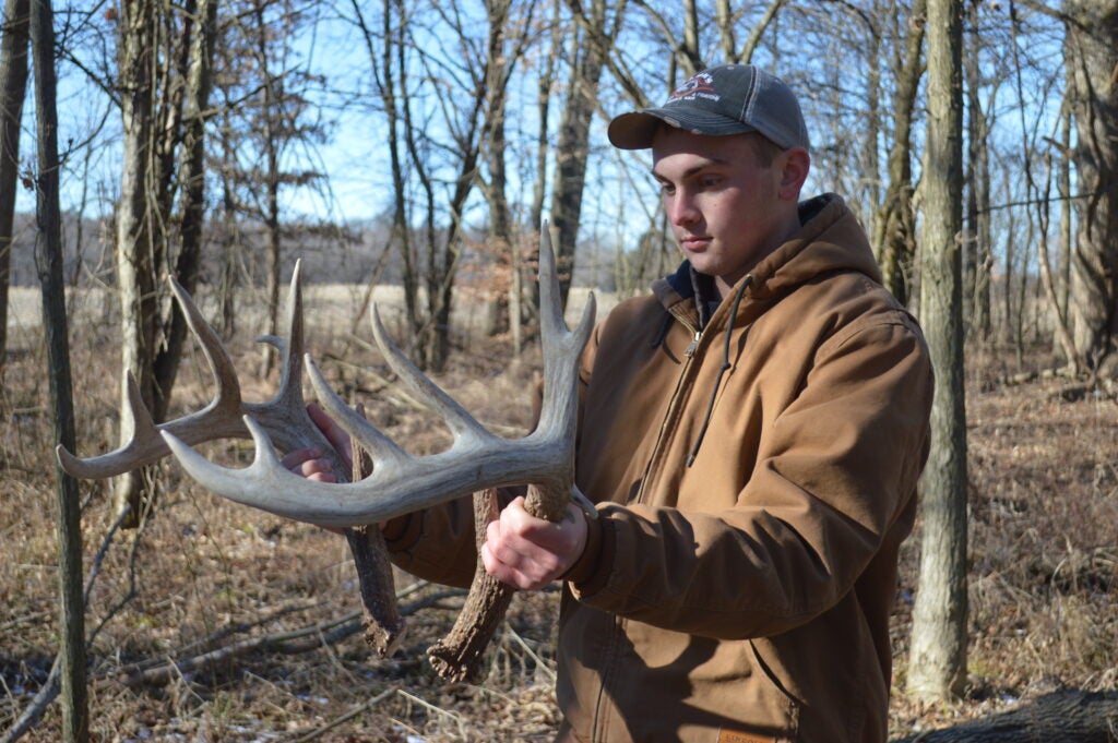 Mann with big matched 10-poin shed antlers 