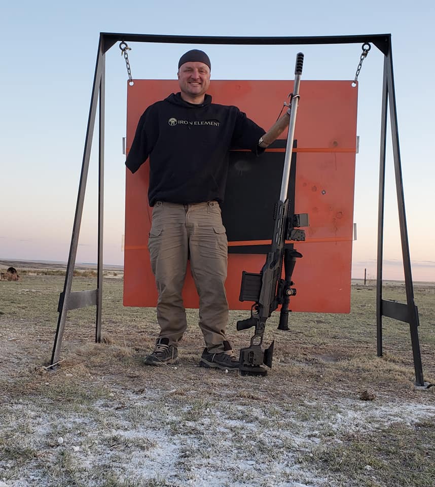 Miesse standing next to the 52-inch steel target he hit at 3 miles. 