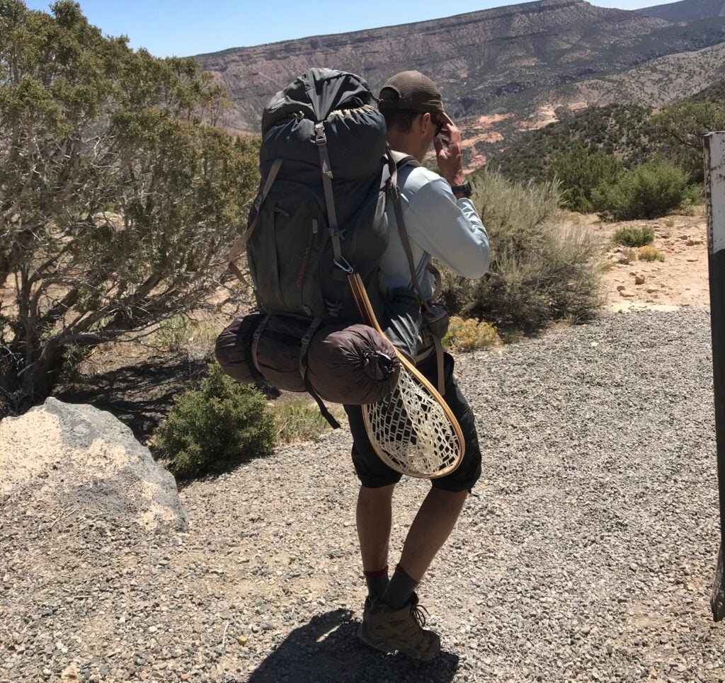 fisherman hiking with a backpack.
