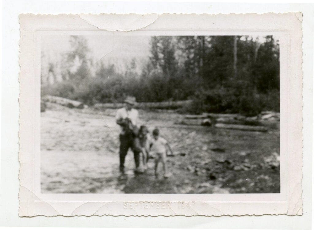 Norman Maclean fishes with his children.