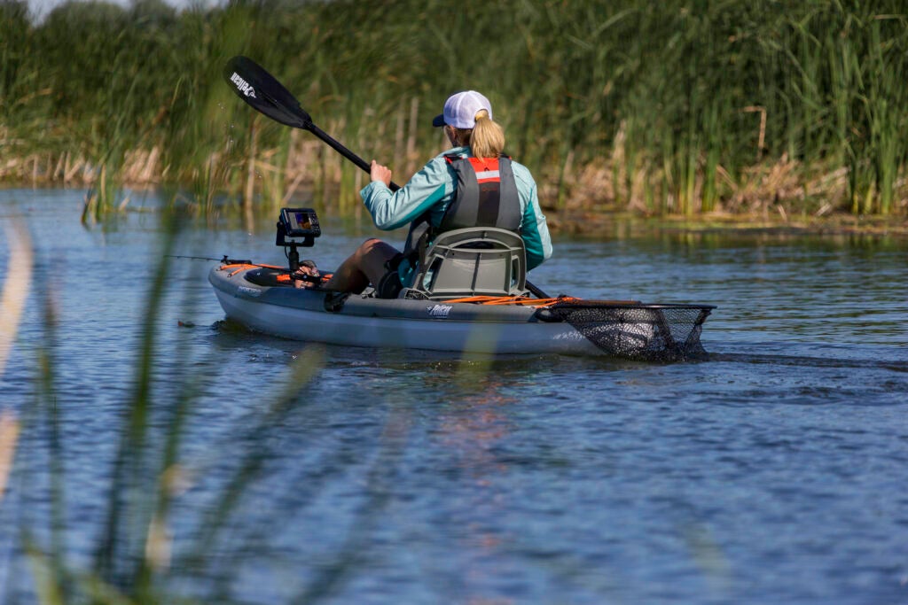 Women paddling kayak with fish finder