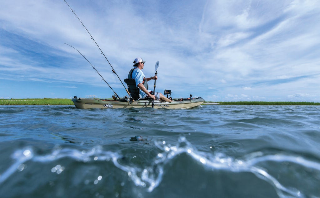 Man paddling kayak with fish finder 