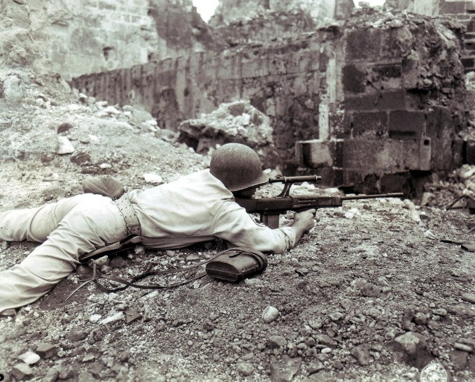 Soldier firing a prototype gun.