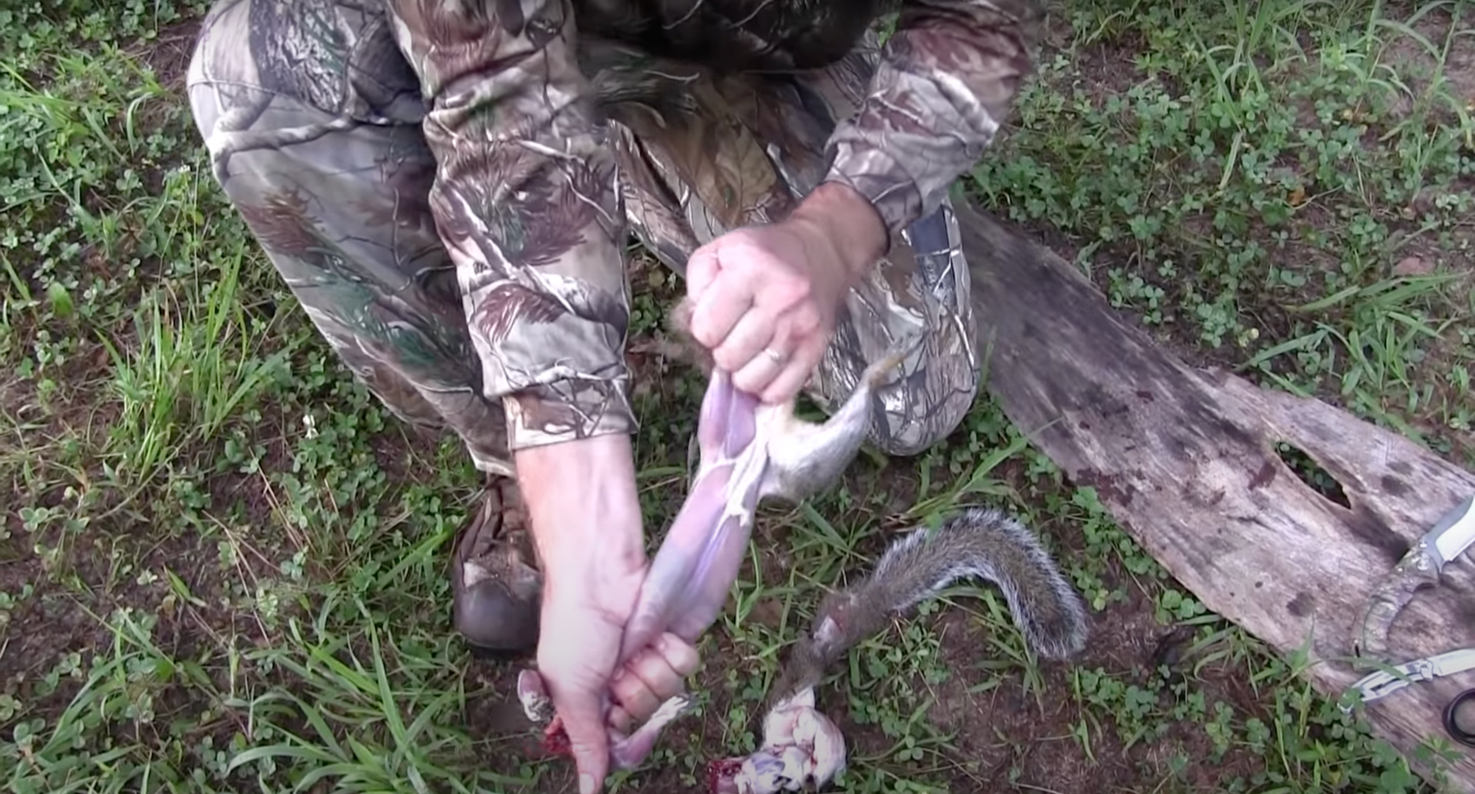 Hunter displaying how to skin a squirrel.