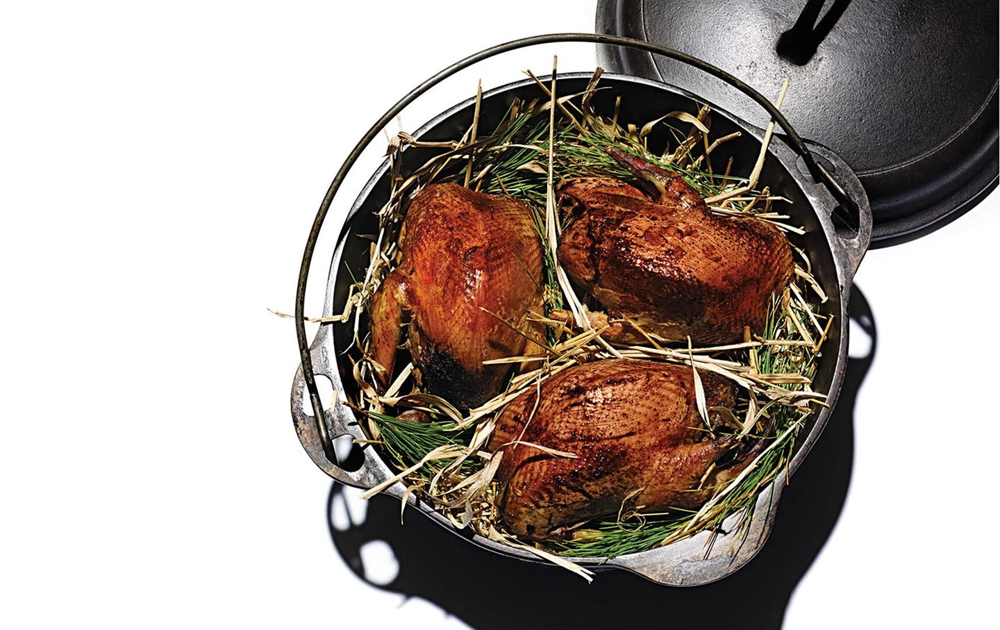 Roasted grouse in a bed of hay and pine.