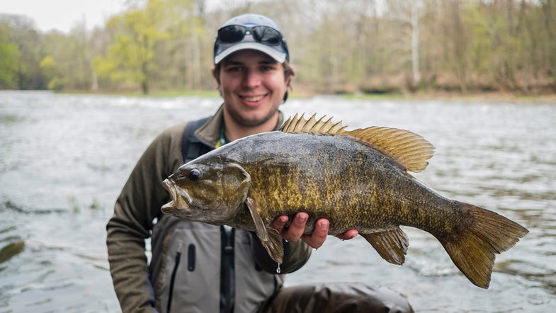 angler holds up smallmouth