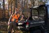 will brantley standing next to a utv with a deer in the bed
