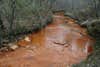 burnt cane creek stained orange from acid mine drainage
