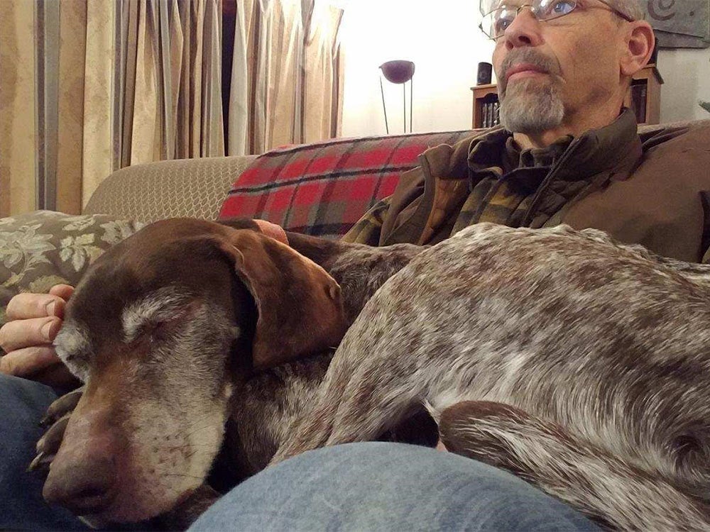 phil bourjaily with a hunting dog in his lap
