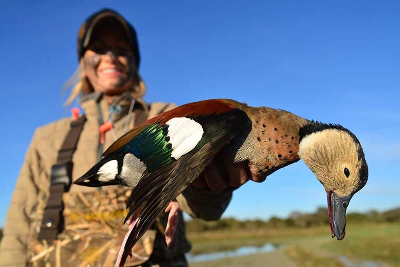 woman hunter holding a ringed teal