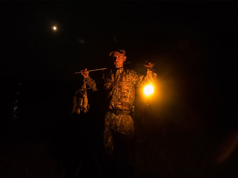 hunter holding squirrels at night