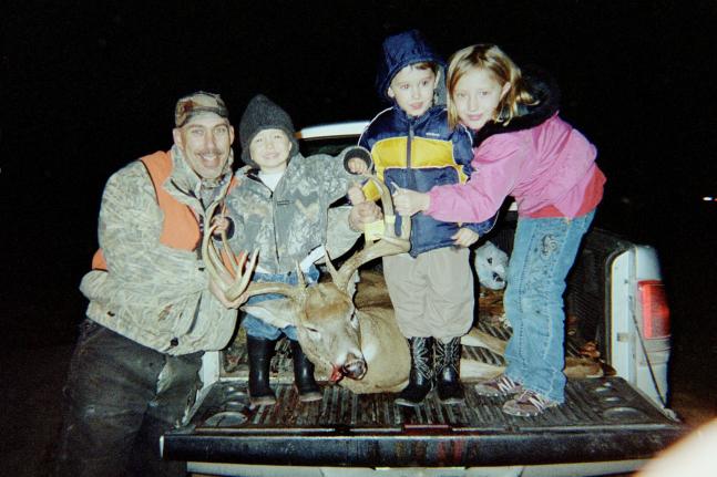 Kaitlynn, Drake, and Gage celebrate with dad after he harvested this 160+ inch North central Missouri whitetail.