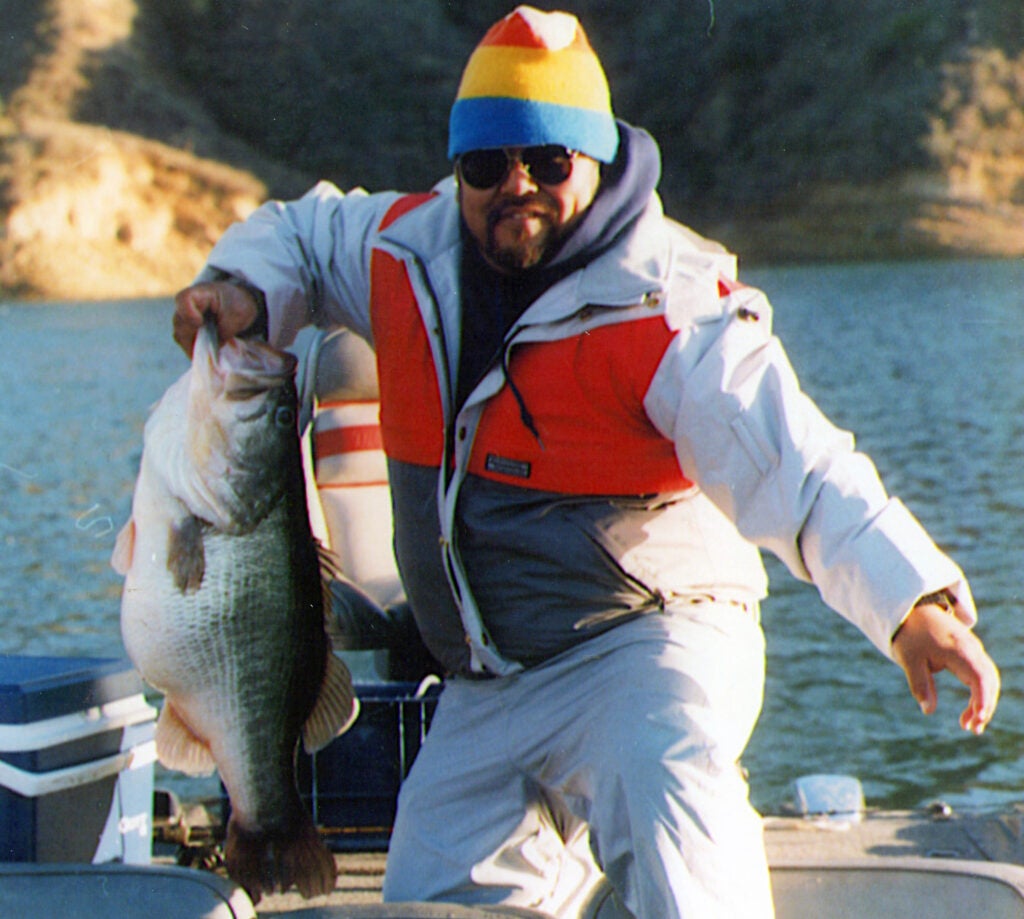 angler holding one of the biggest bass ever