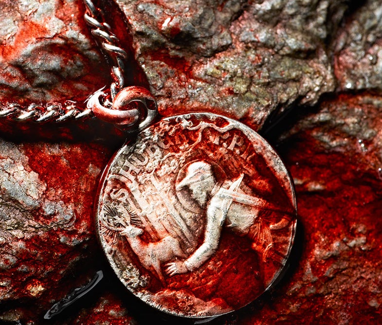 Blood stained necklace medallion.