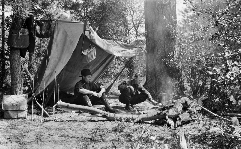 The original handwritten caption dates this photo of two young fishermen cooking over a campfire to the spring of 1915, but they and the photographer remain unidentified. In other photos from this trip, acquired as part of a collection from a Seattle estate sale, -curator Thomas Robinson has identified landmarks around Mount Rainier. "It is clear that the photographer was young, very -interested in wildlife, and spent a lot of time hunting, fishing, and camping," says Robinson. A few months after this photo was taken, the road above Nisqually Glacier was opened to automobiles for the first time, as motorcars were quickly replacing horse-drawn -vehicles in the U.S.<br />
<strong>Location:</strong> Near Mount Rainier, Washington<br />
<strong>Issue:</strong> June, 2011<br />
<em>Photo by: Unknown</em>