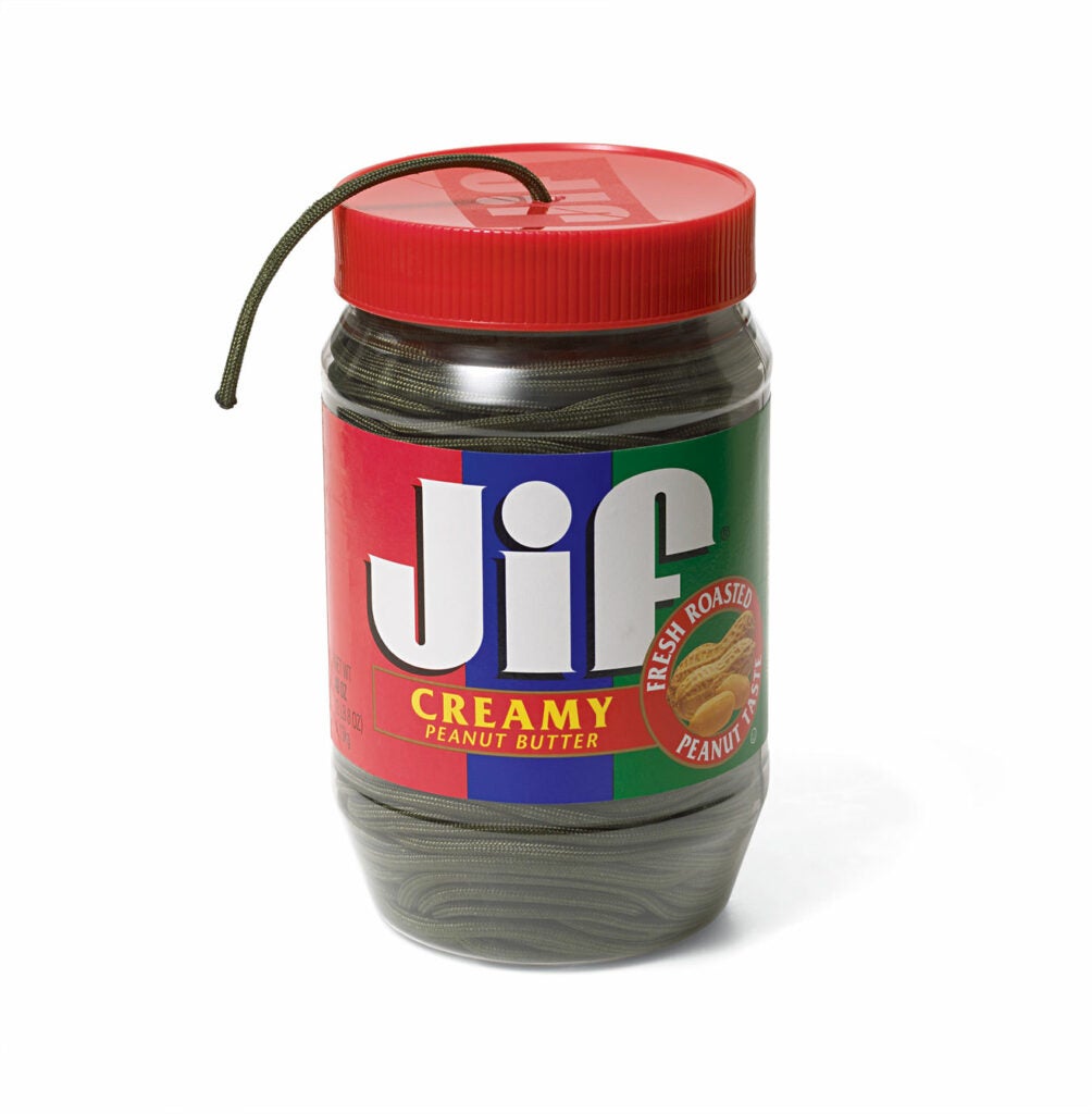 A jif peanut butter jar with a rope pulled out.