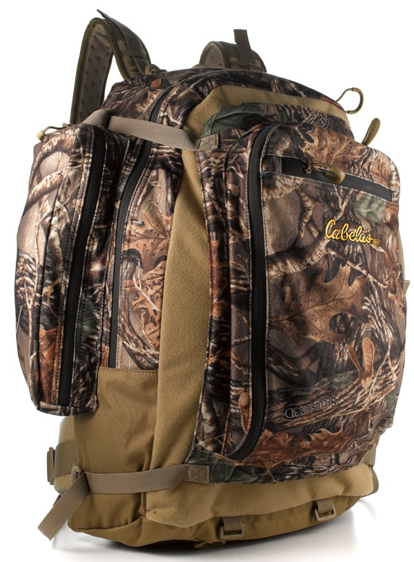 The first thing that strikes you about this durable backpack is its weight. At less than 3 pounds, it felt like a feather compared with the other hunting packs we tested--a serious plus for hunters who tackle tough terrain where every ounce counts. After that, you begin to notice all the smart details that make the Bow and Rifle Pack so great--and worth your money. If you want to lighten your load for a simple day hunt, the front detaches to serve as a daypack. When you're thirsty, you can take a sip from the included (and removable) 70-ounce reservoir. After you stuff all 2,200 cubic inches of the main compartment, the frame balances the load nicely while the ergonomic, mesh-lined back panel keeps you comfortable. Then there's the pack's slick namesake feature: adjustable straps and a foldout bow-cam or -rifle-butt support pouch that securely hold your compound bow, rifle, or crossbow. It comes in four camo patterns as well as a Scent-Lok version ($170). --Colin Kearns<br />
**<br />
Manufacturer:** Cabela's<br />
<strong>Price:</strong> $150