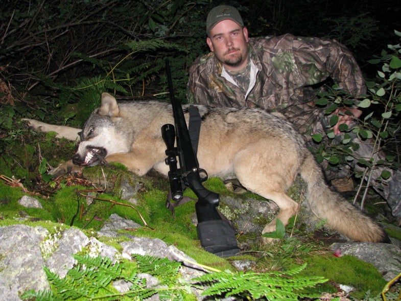 Robert Millage poses with his wolf.