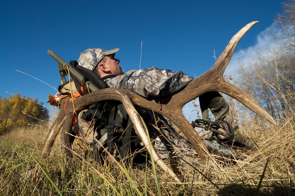 Bowhunter Drew Stoecklein reclines on a 6x6 elk rack after a full day of hunting solo and hours of packing the bull from Gallatin National Forest. Stoecklein called photographer Dusan Smetana to help make two trips to his car, 4 miles away. "Drew got a nice trophy bull," says Smetana, "but it was so much work to pack it out." The pair transported at least 300 pounds of meat and the 100-pound rack down steep, uneven terrain. "When you carry that much for that long, you get lazy enough to lie down with the whole bag," he says.<br />
<strong>Location:</strong> Bozeman, Montana<br />
<strong>Issue:</strong> September, 2010<br />
<em>Photo by Dusan Smetana</em>