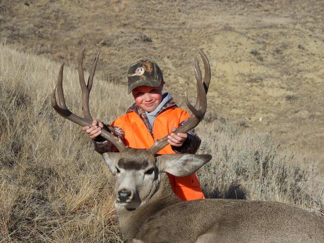 My son Owen holding up our 4x4 Montana muley. Awesome first out-of-state big game hunt for him to be along for!
