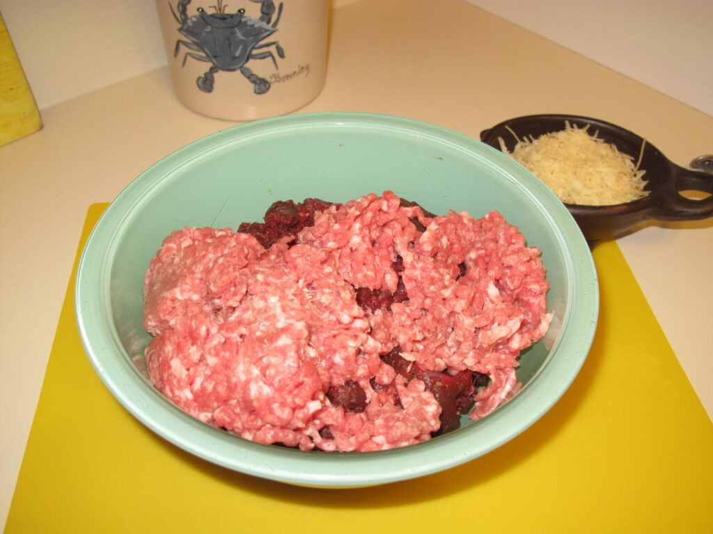 I grind my venison without mixing in any fat, and wait until I'm ready to cook before adding pork fat, tallow, etc. The dark meat is venison, obviously. The other is standard issue ground pork from the grocery store. Go ahead and finely dice onions, then saute them in olive oil until they're about 2/3 cooked. They'll cook the rest of the way as you add heat to the meatballs.