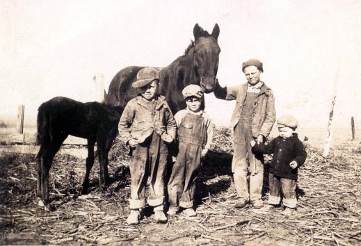Might be a hunting shot - figure they have their slingshots in their back pockets. Life as it was on the farm in ~1930. Either in Auburn or Downs, KS. The little guy on the right is my dad.