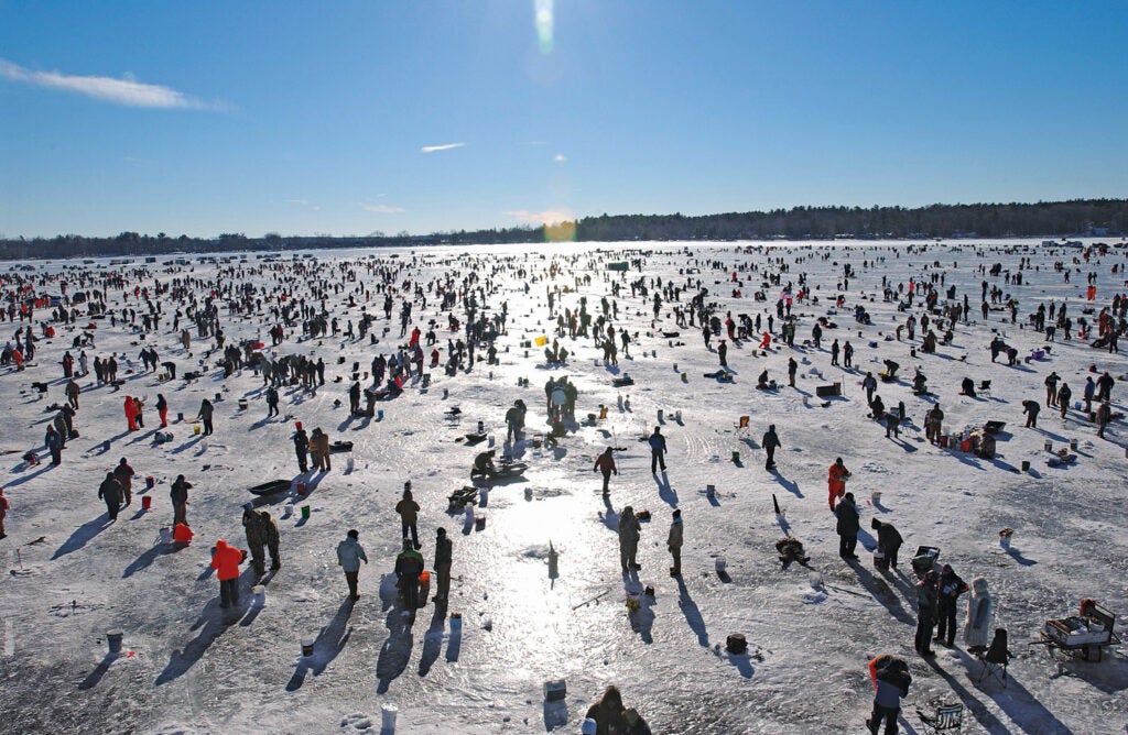 The Brainerd Jaycees' $150,000 Ice Fishing Extravaganza is the largest charitable ice-fishing tournament in the world, drawing participants from 22 U.S. states and six countries to Hole in the Day Bay on Gull Lake. "The event is completely organized by volunteers who basically build a city of tents," says the Brainerd Jaycees' Mary Divine. Populated by 10,000 to 13,000 anglers, it becomes, temporarily, the largest city in Cass County. Participants have three hours to catch and register fish. First place wins a pickup, but 100th place could still win you an ATV or large cash prize. The tournament has raised over $2 million for local charities since 1991.<br />
<strong>Location:</strong> Gull Hale Near Brainerd, Minnesota<br />
<strong>Issue:</strong> February, 2011<br />
<em>Photo by Bill Lindner</em>