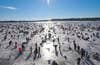 The Brainerd Jaycees' $150,000 Ice Fishing Extravaganza is the largest charitable ice-fishing tournament in the world, drawing participants from 22 U.S. states and six countries to Hole in the Day Bay on Gull Lake. "The event is completely organized by volunteers who basically build a city of tents," says the Brainerd Jaycees' Mary Divine. Populated by 10,000 to 13,000 anglers, it becomes, temporarily, the largest city in Cass County. Participants have three hours to catch and register fish. First place wins a pickup, but 100th place could still win you an ATV or large cash prize. The tournament has raised over $2 million for local charities since 1991.<br />
<strong>Location:</strong> Gull Hale Near Brainerd, Minnesota<br />
<strong>Issue:</strong> February, 2011<br />
<em>Photo by Bill Lindner</em>