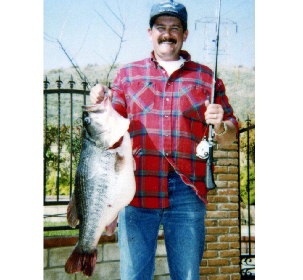 Fisherman holding largemouth bass