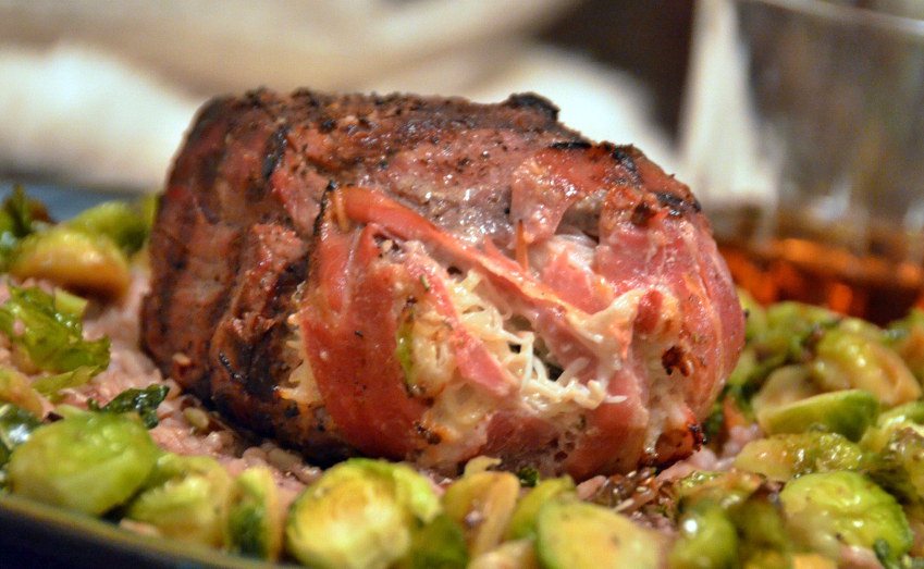 A venison backstrap recipe that features meat stuffed with crab meat on top of brussels sprouts