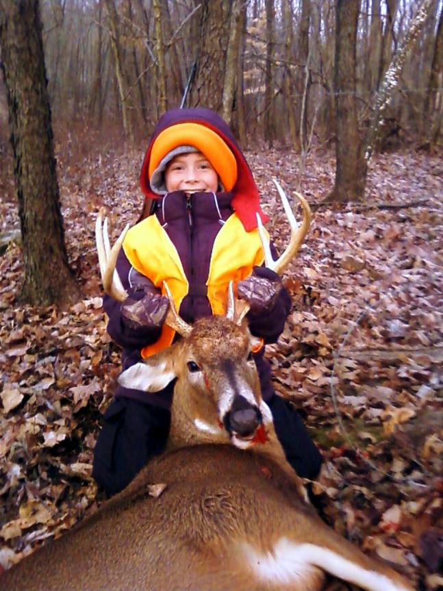 My 9 year old son Jacob and his grandfather, were with me as we were walking into the woods the first Saturday. I happened to look down the hill to my right and there was this big 8 point about 75 yards looking up at us. After firing one shot from MY grandfather's Winchester 88 - I took this picture of my son holding my buck! He was thrilled! That's why we hunt!