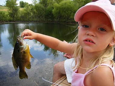 In the world of field fashion, pink just might be the new camo. At least for three-year-old Bailey Hughes. She used a bright pink squid and jig head rigged to her pink Disney Princess rod to land this sunfish.