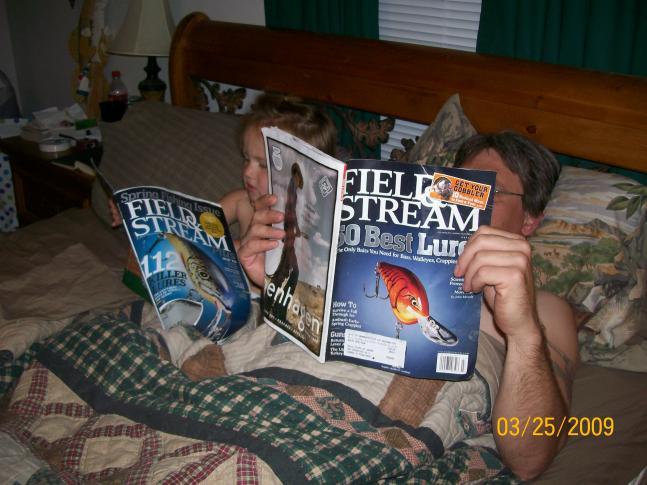 A Father and Daughter spending a lazy off fishing day...Reading their Field &amp; Stream magazines