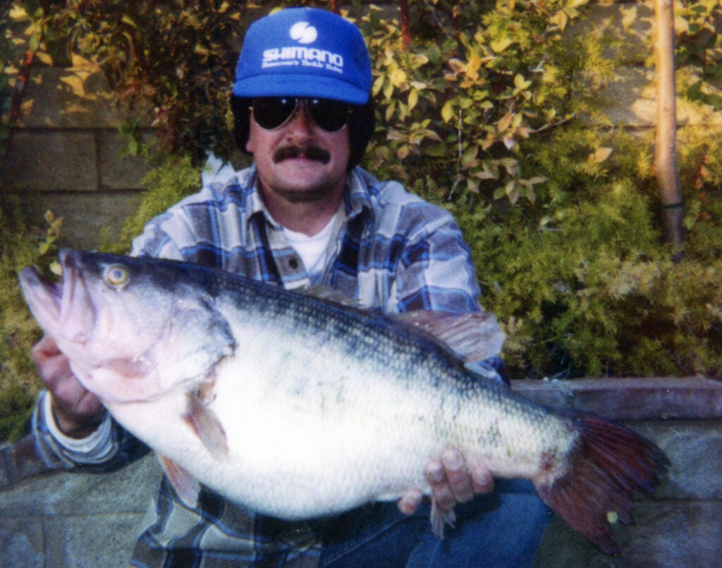 A fisherman holding a large fish