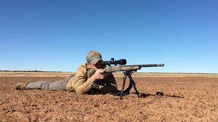 a shooter aiming long range rifle