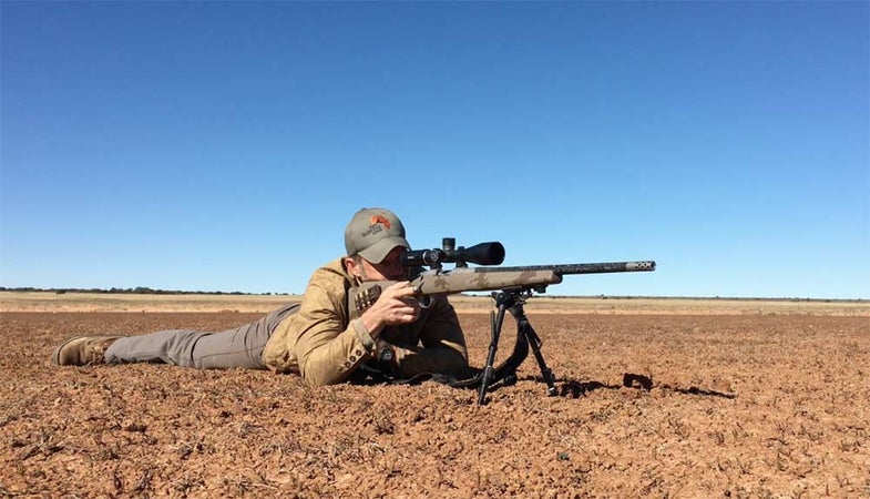a shooter aiming long range rifle