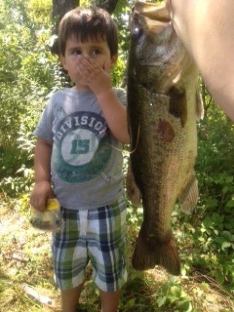 I took my son fishing. He likes big fish but, not the big smell. The picture says it all. He almost vomited. We caught this seven pound large mouth bass with a rubber worm at our new favorite fishing spot. God bless the children and the dads who take them to participate in one of the greatest past times in history!