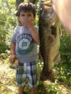 I took my son fishing. He likes big fish but, not the big smell. The picture says it all. He almost vomited. We caught this seven pound large mouth bass with a rubber worm at our new favorite fishing spot. God bless the children and the dads who take them to participate in one of the greatest past times in history!