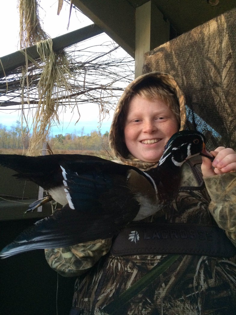 youth hunter with wood duck