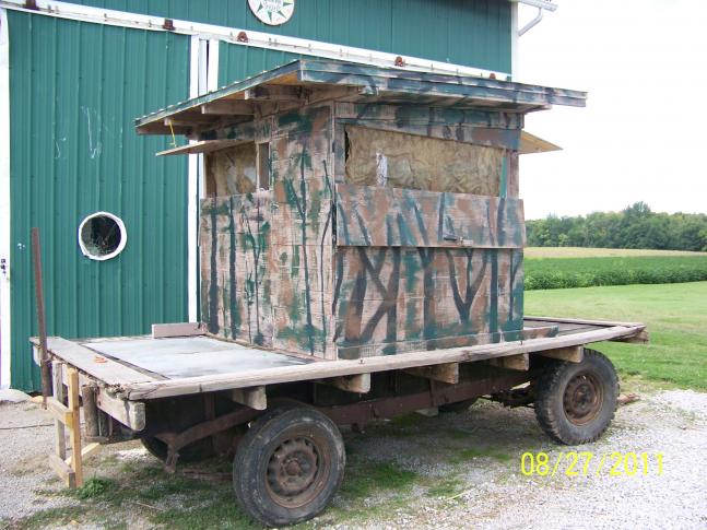 My neighbor gave me an old flat bed wagon that we converted to a portable deer stand. We installed hinged openings on all sides to allow a 360 degree view. To break up our background we have burlap "drapes". Regardless of the weather, we'll have a fairly comfortable place to hunt.
