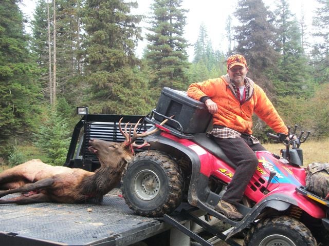 My dad and his friend shot this elk early in the morning. This is one of our 4-wheelers and the flatbed truck we use when we go hunting. This 4 wheeler has gotten us out of many things and the truck makes it easy to load are animals onto and makes it convient to take at least two 4 wheelers anywhere we want.