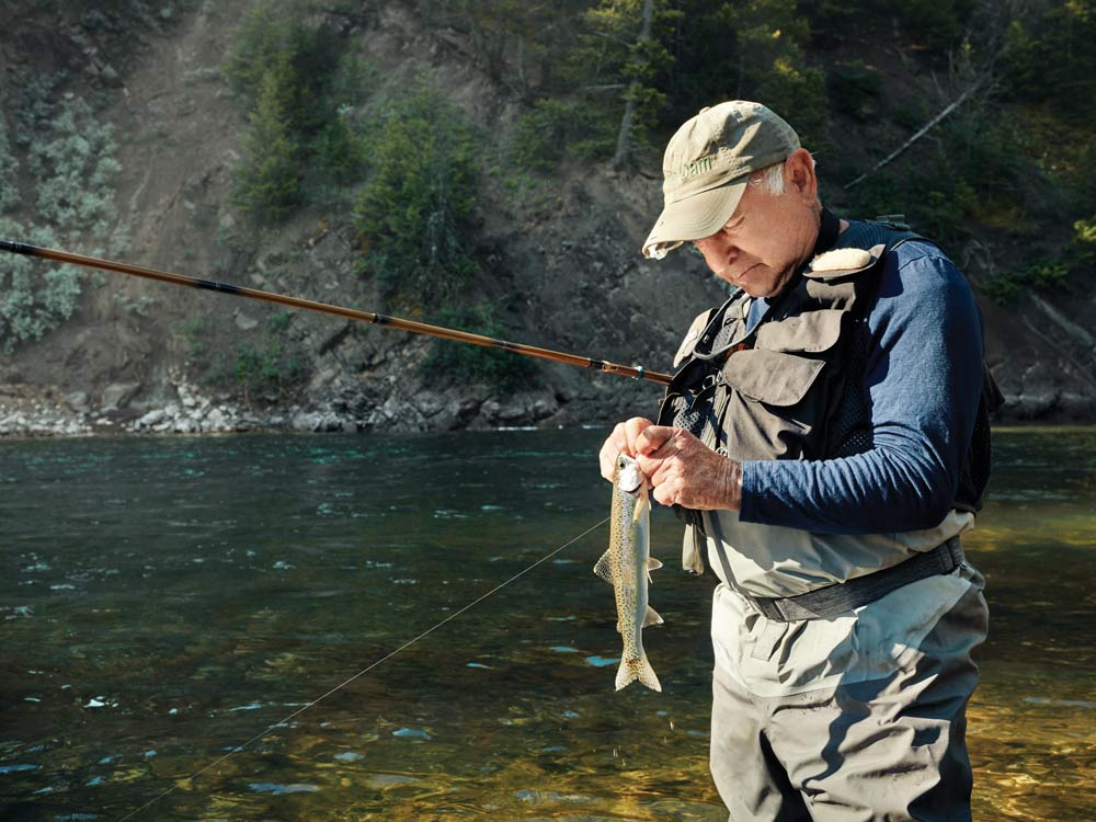 yvon chouinard changing the fly on his tenkara fishing rod