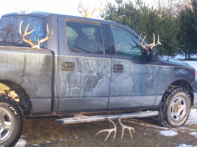 The passenger side just tops it off with 2 world class whitetails and would be a hard desicion to make between a typical or a non typical giant. All artwork airbrushed by my dad