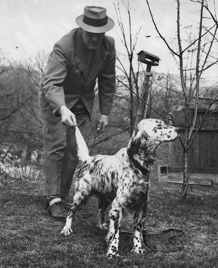 black and white photo of earl twombly and hunting dog