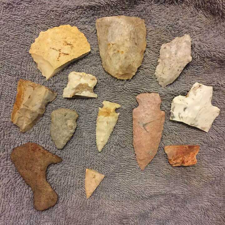 a collectioon of arrowheads and tools