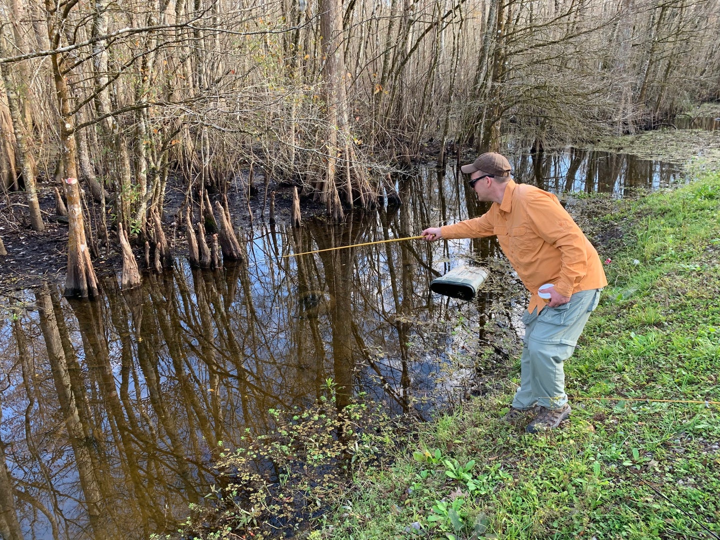 an angler fishing in a small ditch