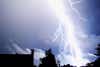 a large bolt of lightning across a blue sky