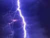 a lightning strike across a purple sky