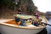 An angler holds up a giant muskie in a Boulder Boat Works drift boat.