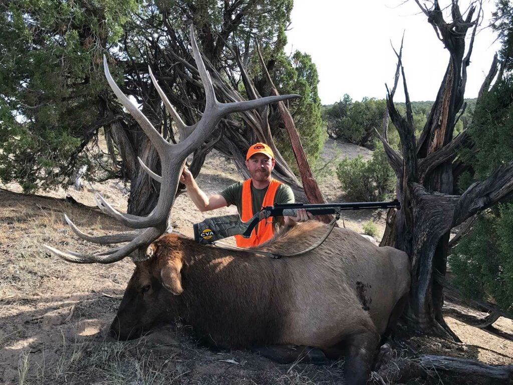 hunter next to giant elk